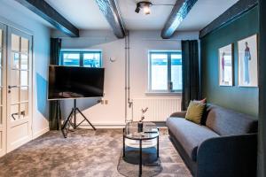 a living room with a couch and a tv at The Churchill Penthouse by Daniel&Jacob's in Copenhagen