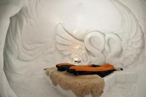 a room with two beds with wings on the wall at Iglu-Dorf Innsbruck Kühtai in Kühtai
