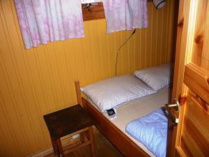 a small room with two beds and a stool at Tosbotn Camping & Cottages in Tosbotnet