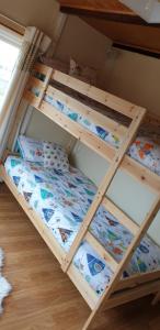 a bunk bed in a room with a bunk bedsheet at Mona Villa Holiday Home in Caulderton