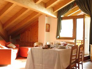 a dining room with a table and a couch at Baita al Pian in Bormio +64 photos