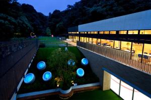 a building with a garden in front of it at Sadie's Home in Waizumi