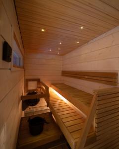 a sauna with two wooden beds and a desk at Northern Lights Ranch in Köngäs