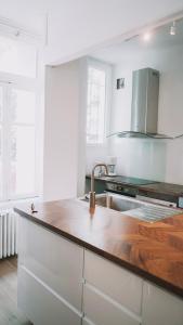 a kitchen with a sink and a wooden counter top at Outsite Coliving Biarritz in Biarritz