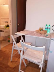 a white table and two chairs in a kitchen at Welcome Home in Milan