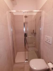 a shower with a glass door in a bathroom at Welcome Home in Milan