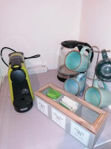 a table with a toaster and a tray with glasses at Welcome Home in Milan +6 photos