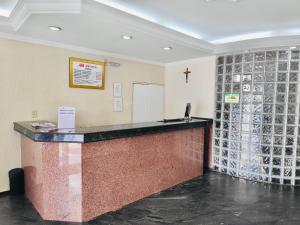 a bar in a church with a cross on the wall at Max Hotel in Brasília