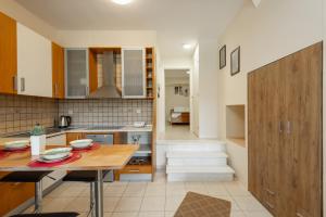 a kitchen with a wooden table and a dining room at Luxury House for all Seasons in Thessaloniki