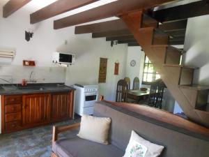 a kitchen with a couch and a table in a room at Grunwald Chales in Monte Verde
