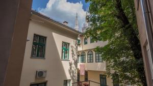 a view of a building with a tower in the background at Dolac Design Apartment 8 in Zagreb