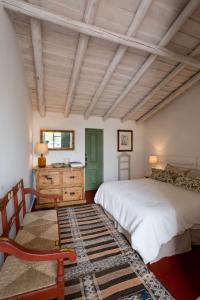 a bedroom with a bed and a wooden ceiling at Casa do Xão in Serpa