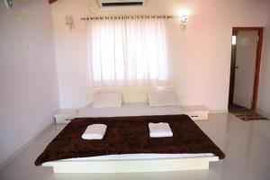 a bedroom with a bed with two towels on it at Rann Resort Dholavira in Dholovira