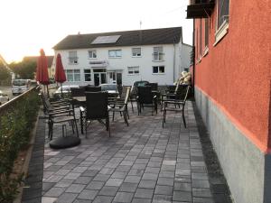 a patio with tables and chairs next to a building at Hotel Einstein in Bad Krozingen