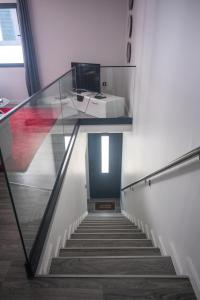 a stairway with a glass railing and a stair case at Grannies House in Machico