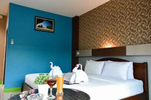 a hotel room with a bed with two swans on it at Chongkhao Resort- SHA Certified in Phi Phi Don