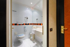 a bathroom with a toilet and a sink at Admiral Art Hotel in Rimini