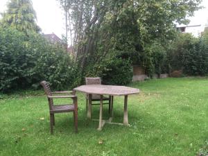 a table and two chairs sitting in the grass at Ferienwohnung Wilde - Coriansberg in Itzehoe