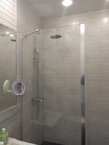 a shower with a glass door in a bathroom at Шикарные Апартаменты in Polatsk