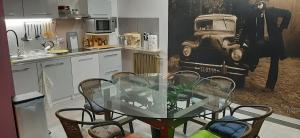 a kitchen with a glass table and chairs in a kitchen at Willa Mercedes in Gorzów Wielkopolski