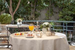 a white table with food and drinks on it at Relais & Châteaux Hotel Orfila in Madrid
