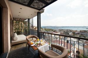 a dining room table with a balcony overlooking the ocean at Georges Hotel Galata in Istanbul