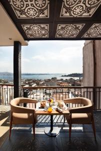 a dining room table with chairs and umbrellas at Georges Hotel Galata in Istanbul