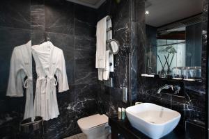 a black bathroom with a sink and a toilet at Georges Hotel Galata in Istanbul