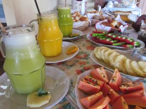 a table topped with plates of food and drinks at D'Elber Pousada in Serra do Cipo