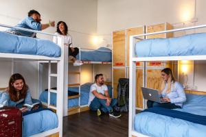 a group of people sitting on bunk beds at Pariwana Hostel Santiago in Santiago