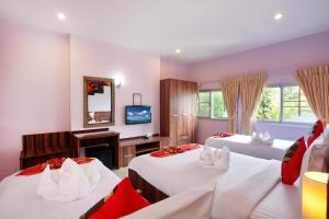 a hotel room with two beds and a television at U Sabai Living Hotel in Patong Beach +64 photos