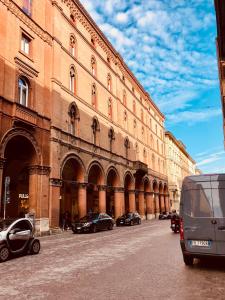 a large building with cars parked in front of it at Indipendenza Luxury Apartments in Bologna