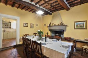 a dining room with a table and a fireplace at Villa Casa Rosa in Lucca