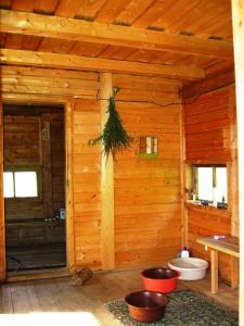 a bathroom in a log cabin with a toilet at Pilkalnes muiža in Nereta