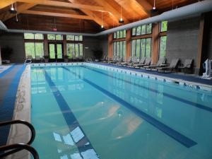 a large swimming pool with chairs in a building at Skamania Lodge in Stevenson +23 photos