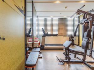 a gym with cardio equipment in a room at Atour Hotel Wuhan Changqing Road Branch in Wuhan