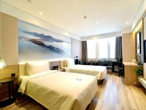 Postel nebo postele na pokoji v ubytování Atour Hotel Wuhan Changqing Road Branch