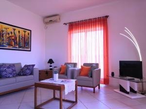 a living room with two couches and a tv at Sal Service Santana double bedrooms sea view angulo in Santa Maria