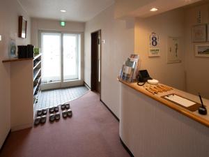 a room with a counter with shoes on the floor at Shimanoyado Rebunshiri in Rebun