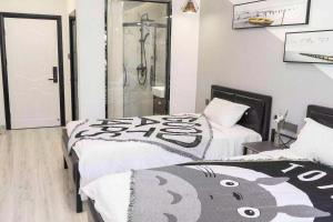 Voodi või voodid majutusasutuse Xiamen Guiran Hostel toas