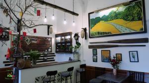 a bar with a tv hanging on the wall at Tam Coc Sweet Home in Ninh Binh