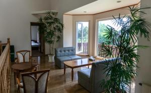 a living room with plants and a table and chairs at Niseko Ski Lodge - Higashiyama in Niseko