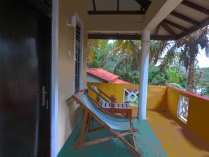 a rocking chair on the porch of a house at Beach Lagoon Guesthouse in Tangalle