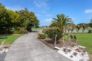 a walkway in a park with trees and bushes at Breakaway Bed & Breakfast in Coromandel Town