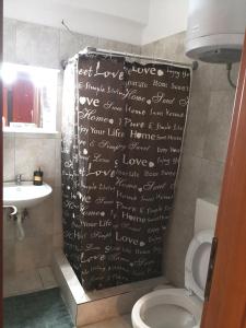 een badkamer met een douchegordijn met een opschrift bij House in the center of Piraeus next to the port and the metro!! in Piraeus