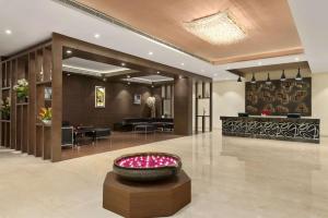 a lobby with a large bowl in the middle of a room at Ramada Neemrana in Neemrana