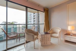 a room with a table and chairs and a large window at Mike Beach Resort in Pattaya