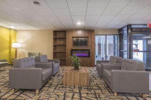 a waiting room with couches and a tv at Quality Inn & Suites Downtown Windsor, ON, Canada in Windsor