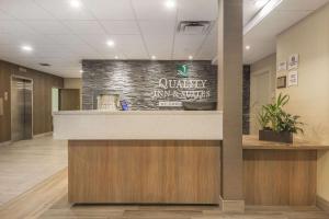 a lobby of a university hospital with a reception counter at Quality Inn & Suites Windsor - Downtown in Windsor