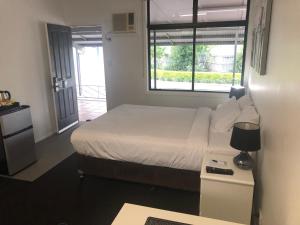 a small bedroom with a bed and a window at Darra Motel & Conference Centre in Brisbane